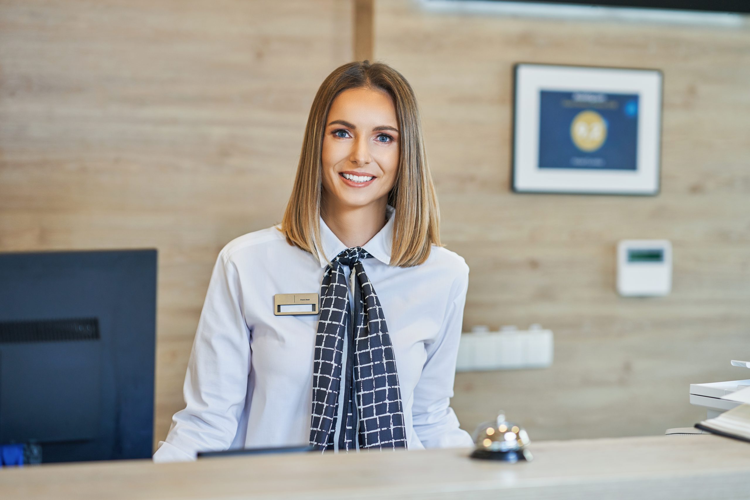 Picture of smiling receptionist at hotel front desk